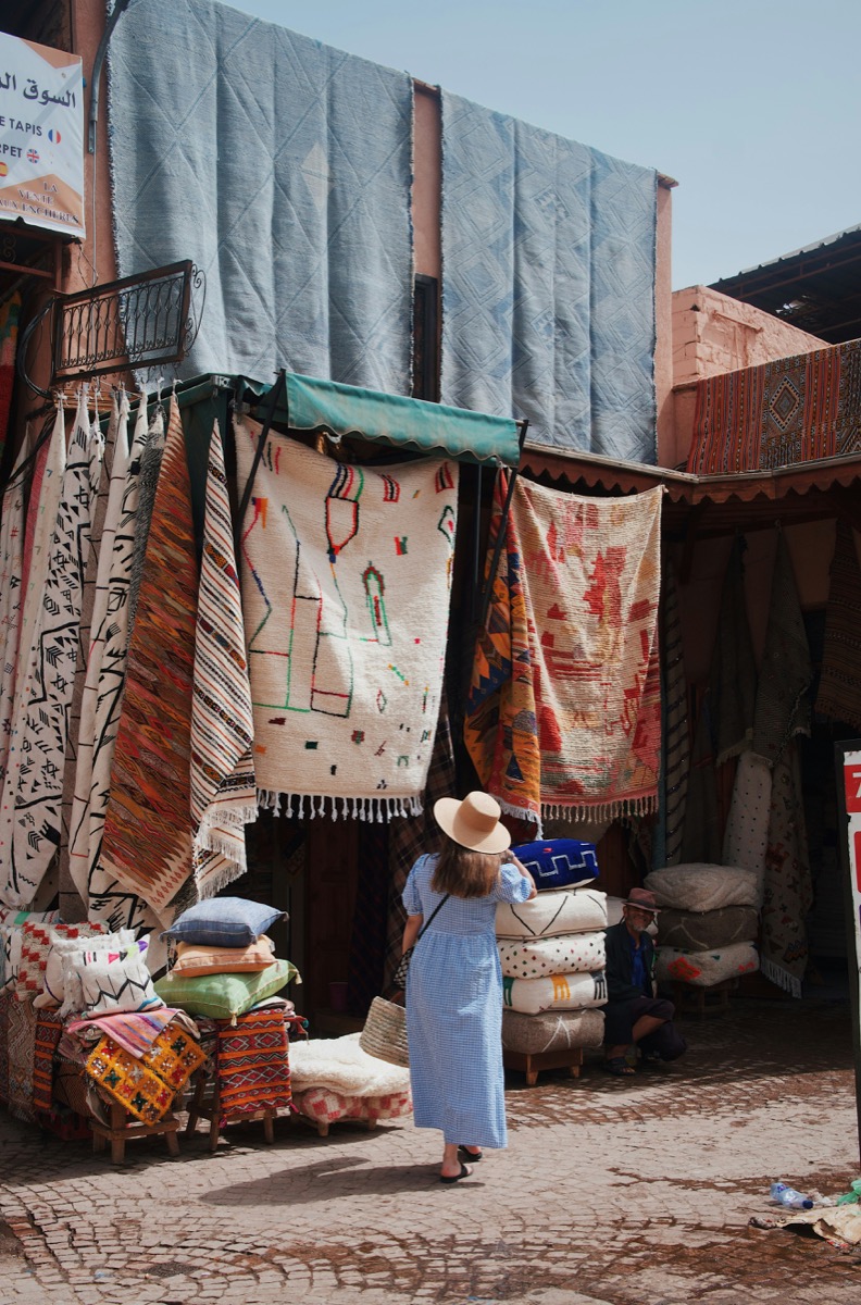 Hand-knotted Berber rugs hanging in a Marrakech rug souk
