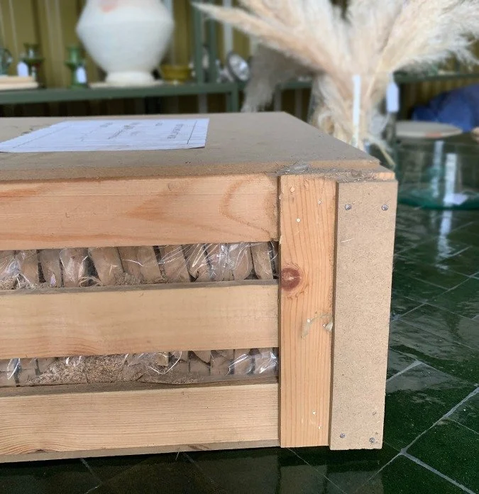 Pigmented cement tiles packed in a wooden crate with straw, ready for ocean freight